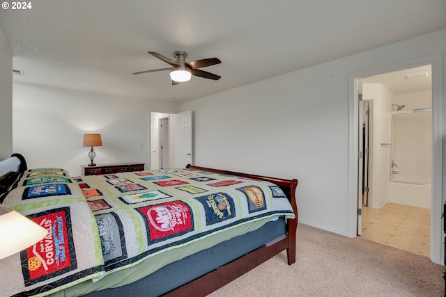 carpeted bedroom featuring ensuite bath and ceiling fan