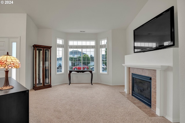 carpeted living room featuring a fireplace