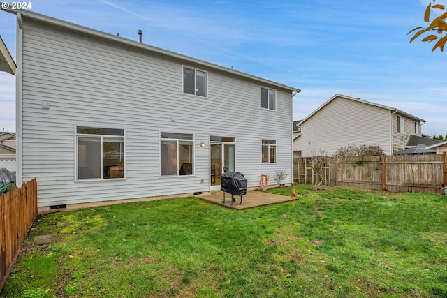 back of property featuring a yard and a patio