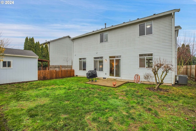 rear view of house featuring central AC unit, a patio area, and a lawn