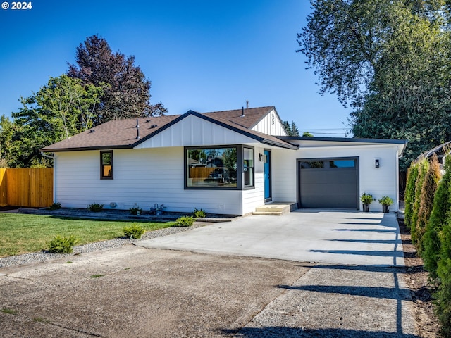 view of front of house featuring a garage and a front lawn