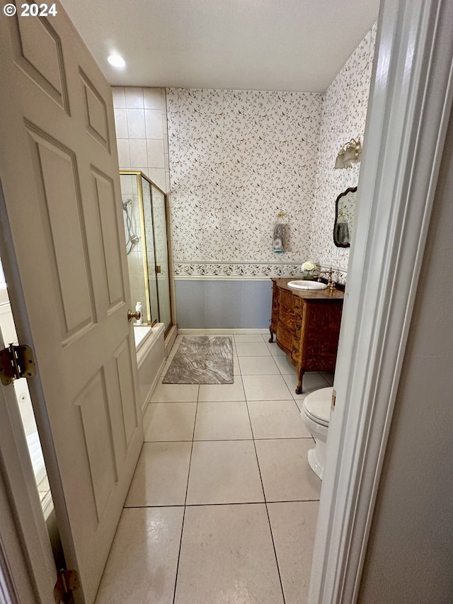 bathroom with tile patterned flooring, vanity, and toilet