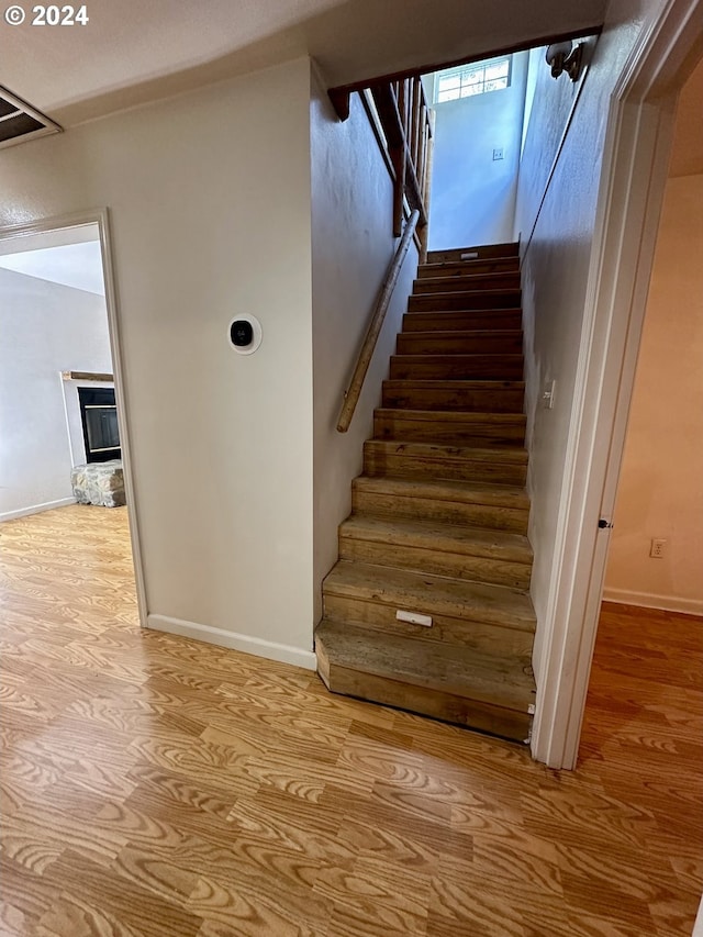 stairway featuring wood-type flooring