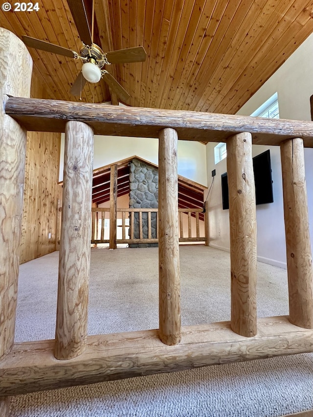 exterior space with a wealth of natural light, wood ceiling, ceiling fan, high vaulted ceiling, and carpet floors