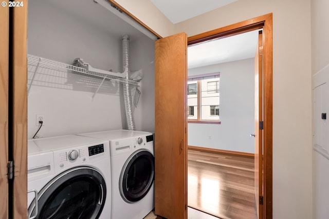 laundry room featuring light hardwood / wood-style floors and washing machine and dryer