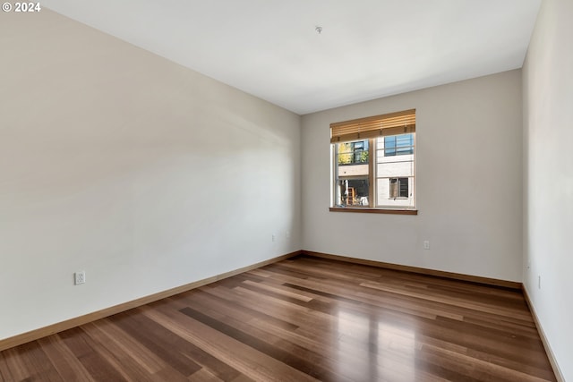 spare room with dark wood-type flooring