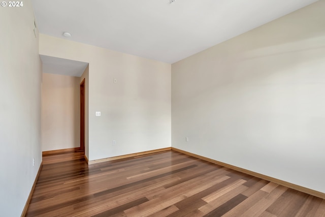 unfurnished room with dark hardwood / wood-style floors