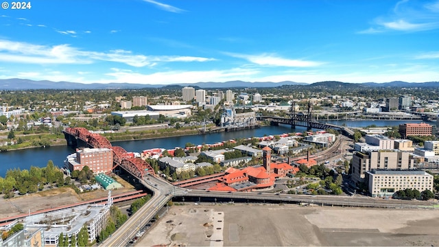 drone / aerial view with a water and mountain view