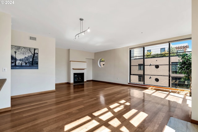 unfurnished living room featuring dark hardwood / wood-style flooring