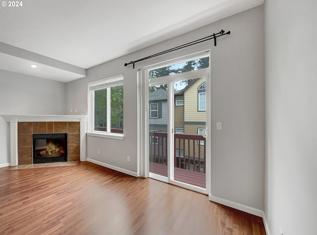 entryway featuring wood-type flooring and a fireplace