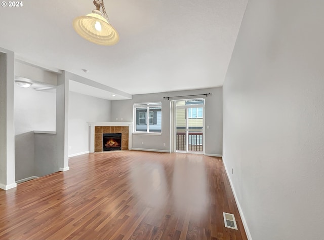 unfurnished living room with hardwood / wood-style flooring and a fireplace