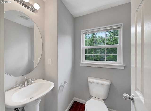 bathroom with hardwood / wood-style floors, sink, and toilet