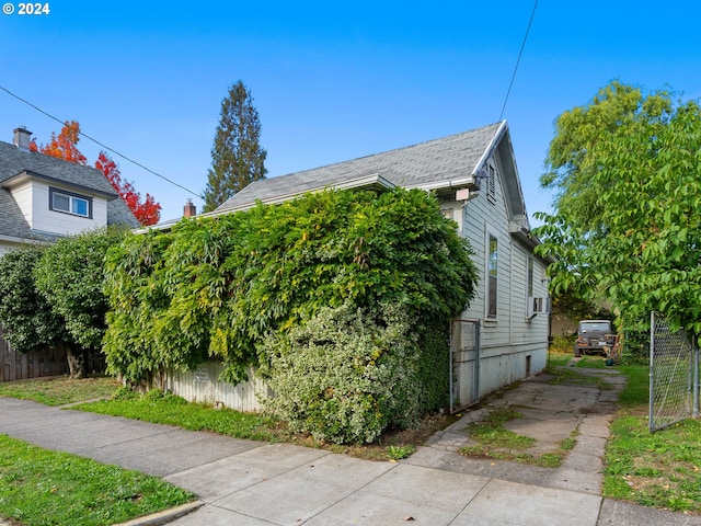 view of side of property with cooling unit