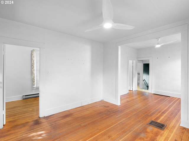 unfurnished room with hardwood / wood-style flooring, a baseboard radiator, and ceiling fan