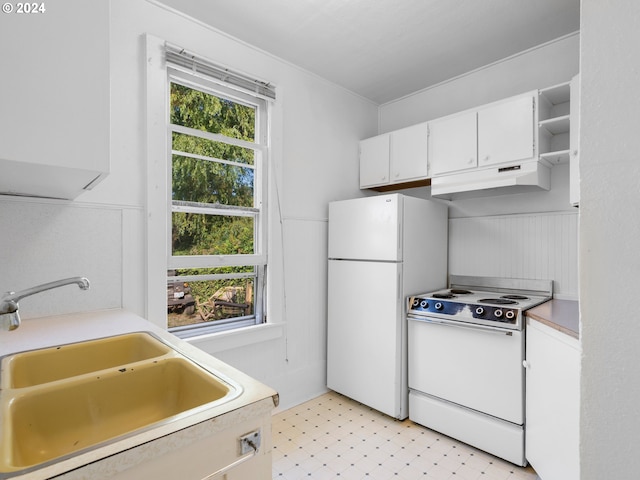 kitchen with white appliances, a healthy amount of sunlight, sink, and white cabinets