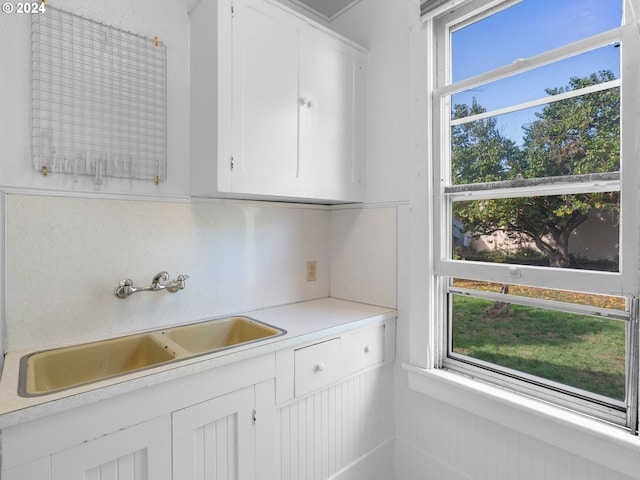 interior space with sink and white cabinetry