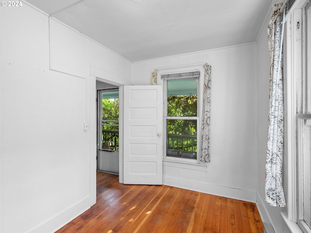 unfurnished room with crown molding and dark hardwood / wood-style flooring