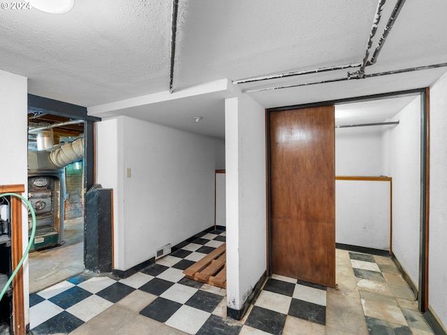 basement featuring a textured ceiling