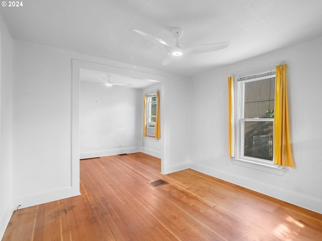 spare room with hardwood / wood-style floors and ceiling fan