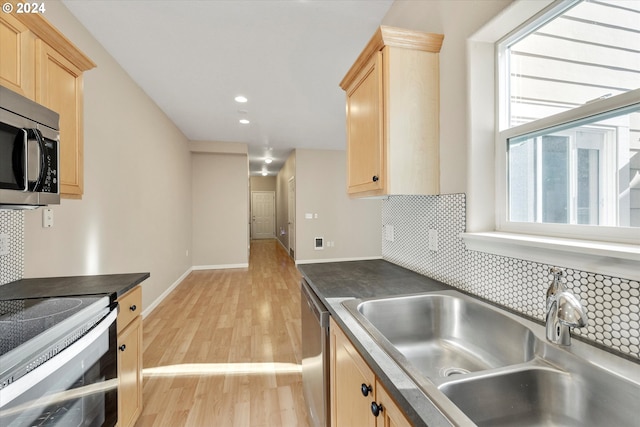 kitchen with decorative backsplash, appliances with stainless steel finishes, light brown cabinets, and sink