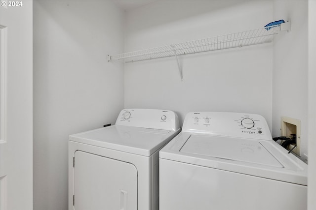 clothes washing area featuring independent washer and dryer