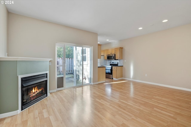 unfurnished living room with light wood-type flooring