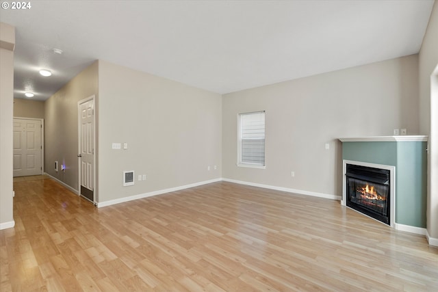 unfurnished living room with light wood-type flooring