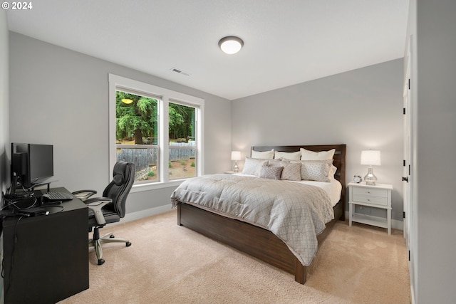 carpeted bedroom featuring multiple windows