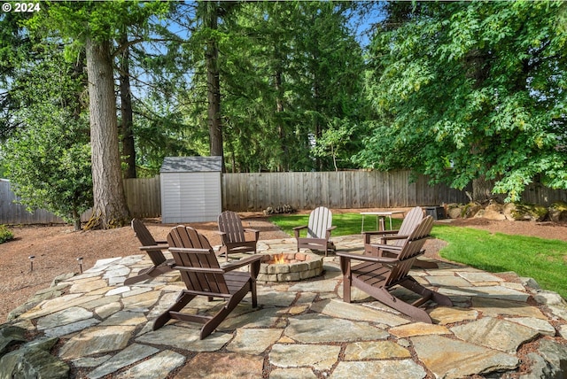 view of patio / terrace with a storage unit and an outdoor fire pit