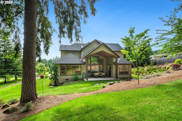 rear view of property with a patio area and a yard