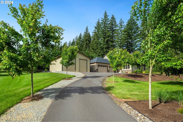 view of front of home featuring a garage and a front yard