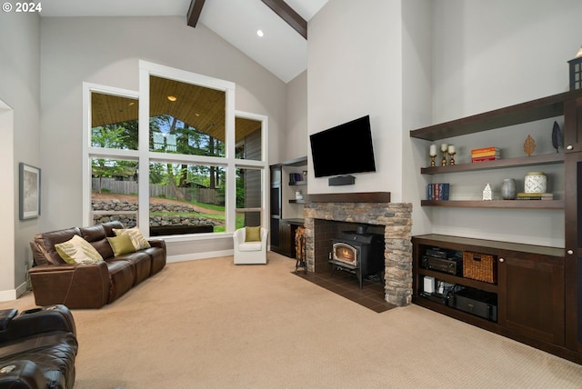 living room with carpet, beam ceiling, high vaulted ceiling, and a wood stove