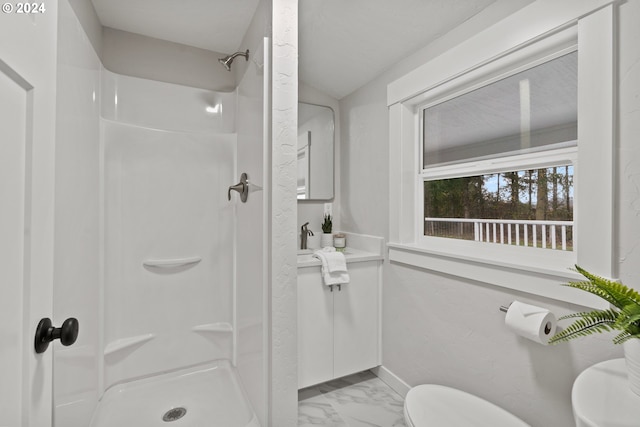 bathroom featuring walk in shower and toilet