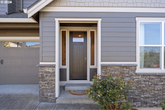 view of exterior entry featuring a garage