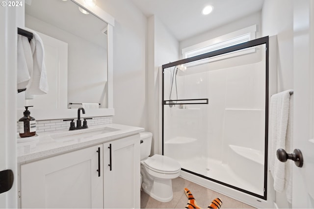 bathroom with decorative backsplash, vanity, toilet, and an enclosed shower