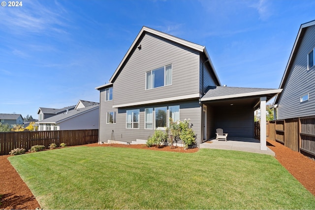 back of property with a patio and a yard