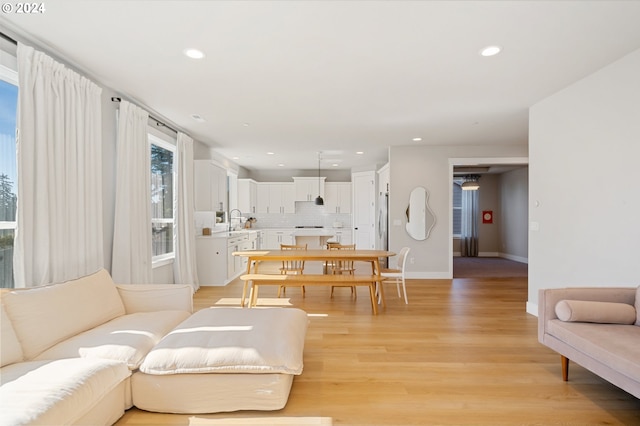 living room featuring light wood-type flooring and sink