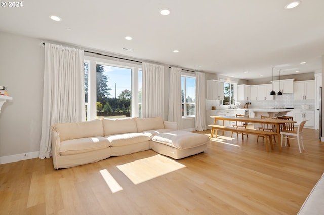 living room with sink and light hardwood / wood-style floors