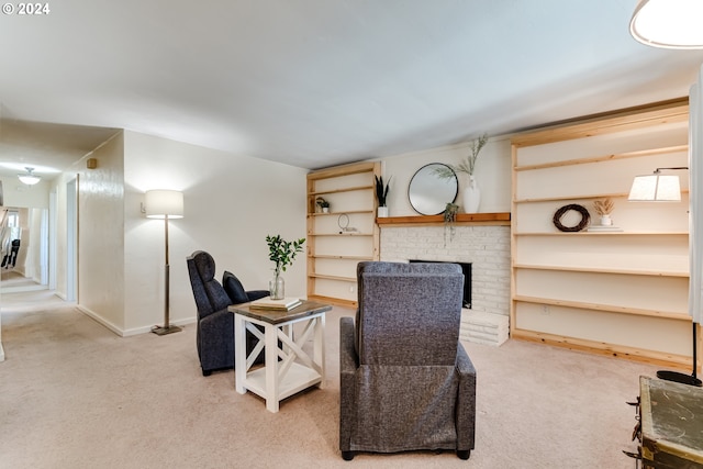 sitting room with carpet flooring and a fireplace