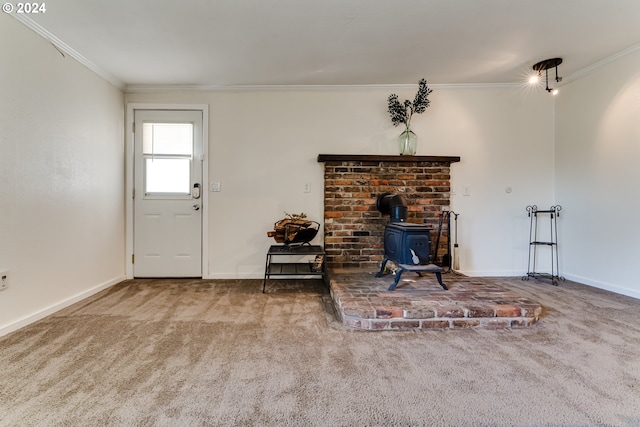 unfurnished living room with ornamental molding, carpet flooring, and a wood stove