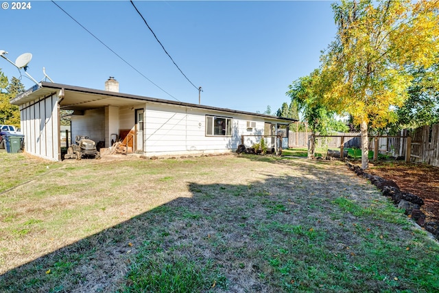 rear view of house with a lawn