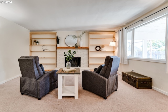 living room featuring light colored carpet and a brick fireplace