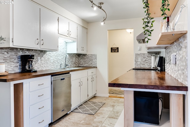 kitchen with white cabinetry, dishwasher, and wood counters