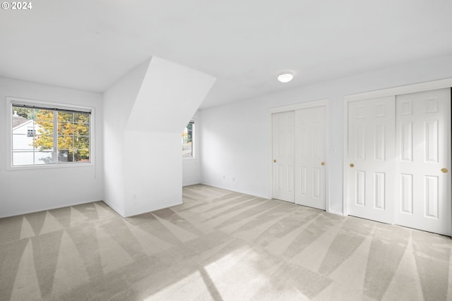 bonus room with light colored carpet