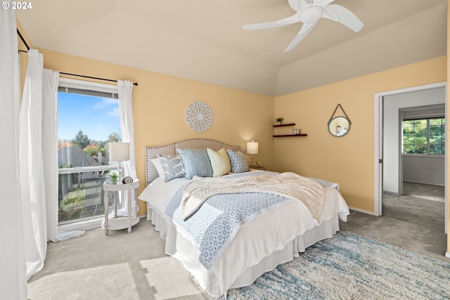 carpeted bedroom featuring lofted ceiling and ceiling fan