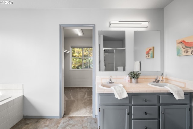 bathroom featuring vanity and independent shower and bath