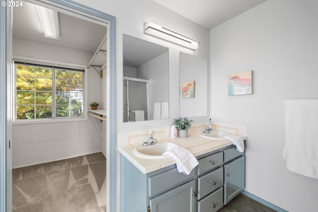 bathroom with an enclosed shower and vanity