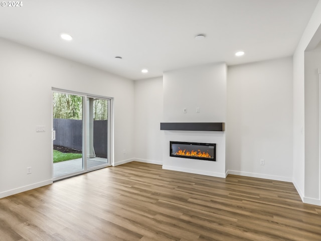 unfurnished living room featuring wood-type flooring