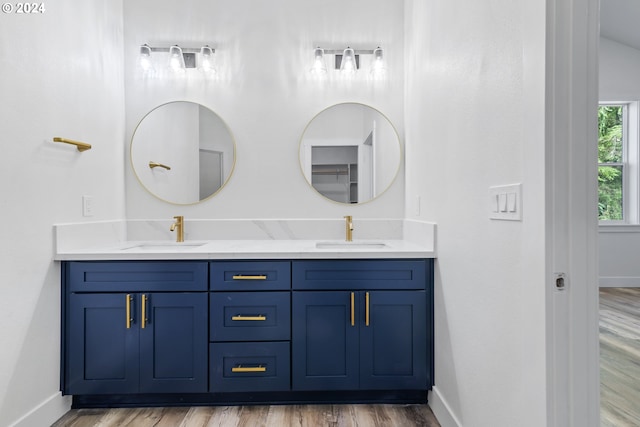 bathroom featuring hardwood / wood-style floors and double vanity