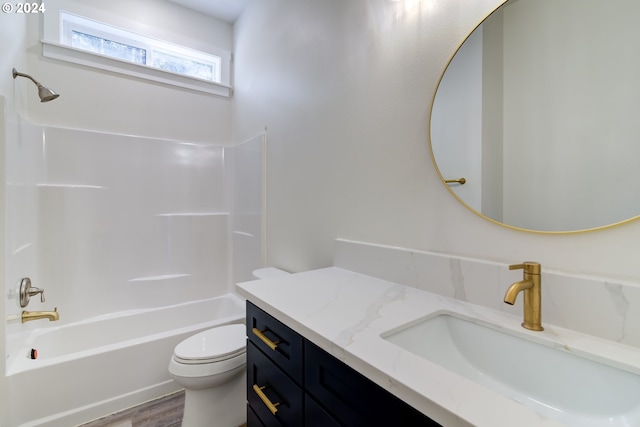 full bathroom featuring toilet, large vanity, hardwood / wood-style flooring, and tub / shower combination